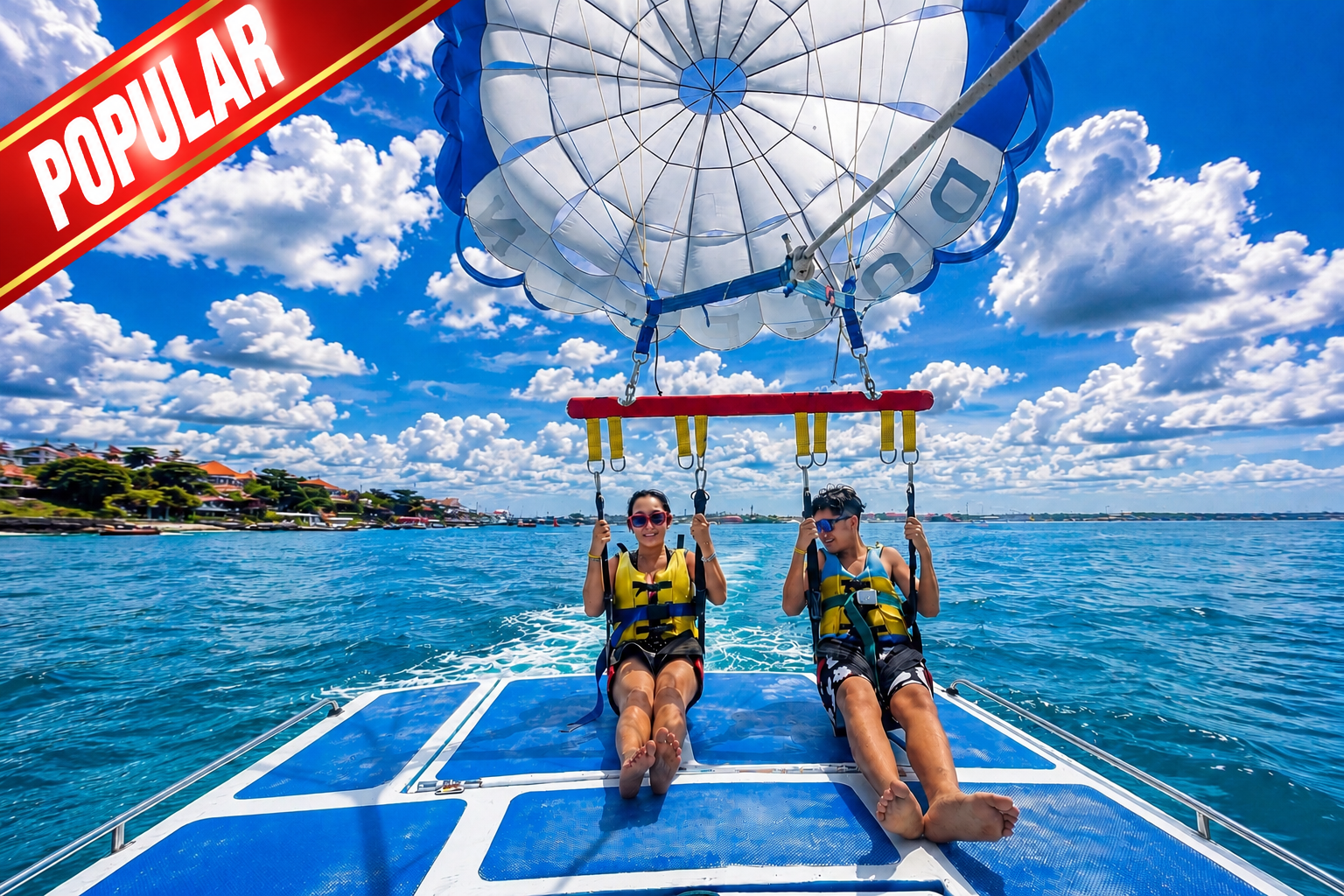 Person parasailing in Bali during water activity above the ocean at Benoa Beach
